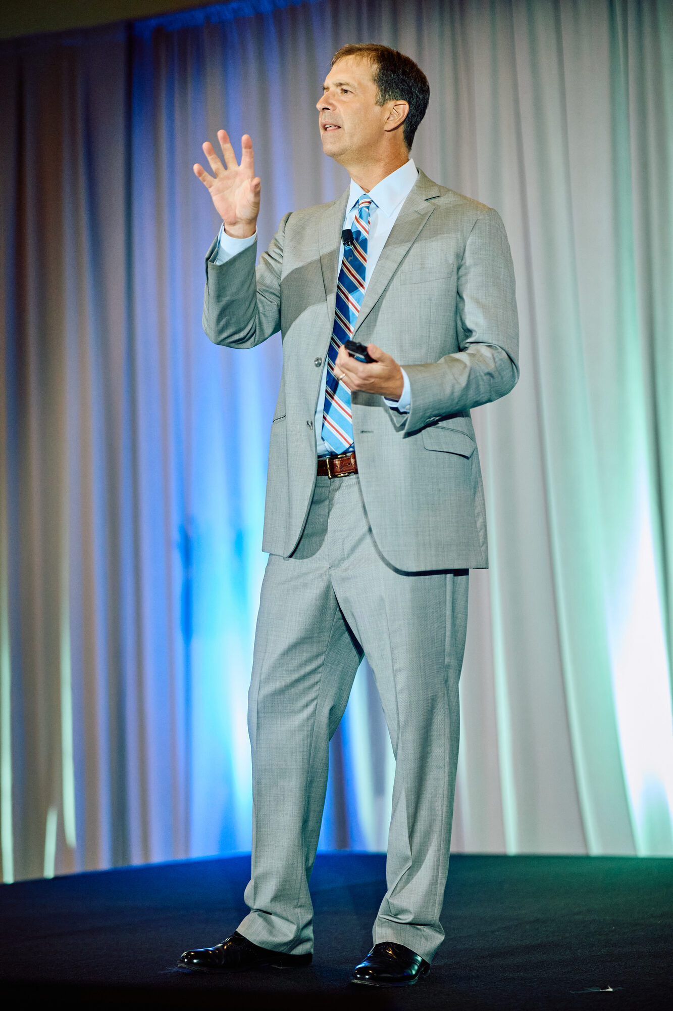 Cam Marston speaking on stage